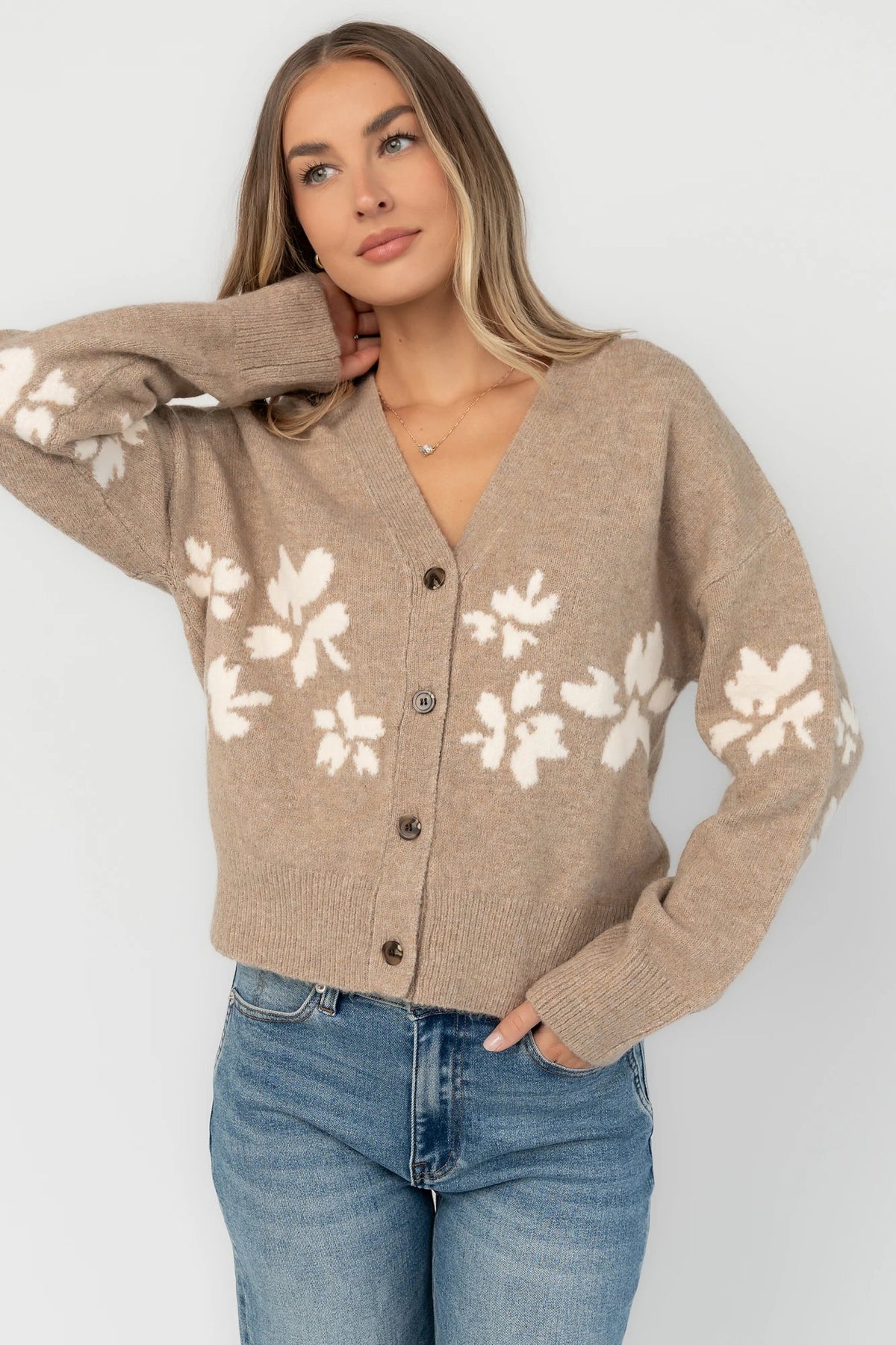 Taupe floral knit cardigan with a V-neckline, button-front closure, long sleeves, ribbed trim, and a relaxed silhouette.