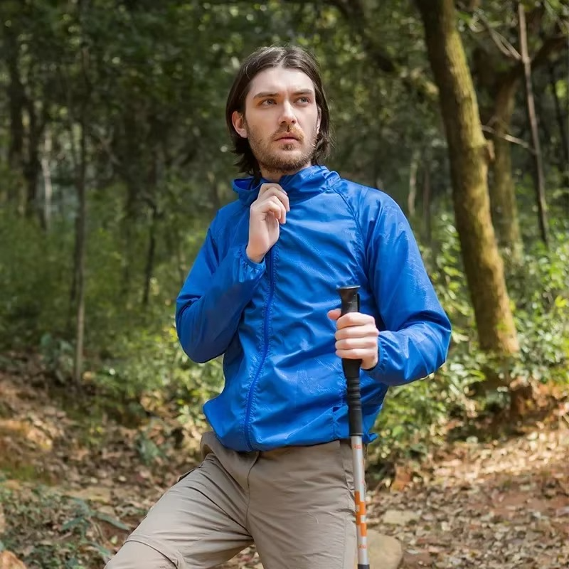 Rain Repellent Hiking Jacket with Adjustable Hood and Breathable Polyester, Packable Design for Men and Women